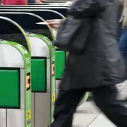 Commuters passing through the station's automatic ticket gates. Semiconductors made from silicon wafers are used in the IC card readers.