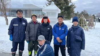 A group photo of six participants standing with their completed snow lanterns.
