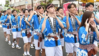 Festival participants dancing in a parade.