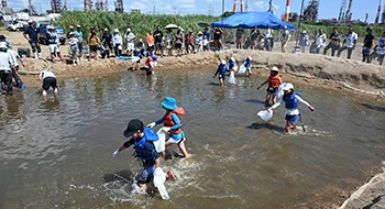 Children at a community event playing by the water.
