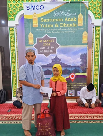 Handing a donation to a local child.